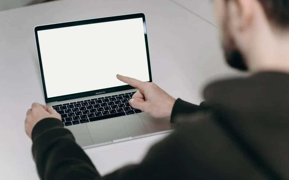 A creative workspace featuring UI design plans, pencils, a smartphone, and other office tools.